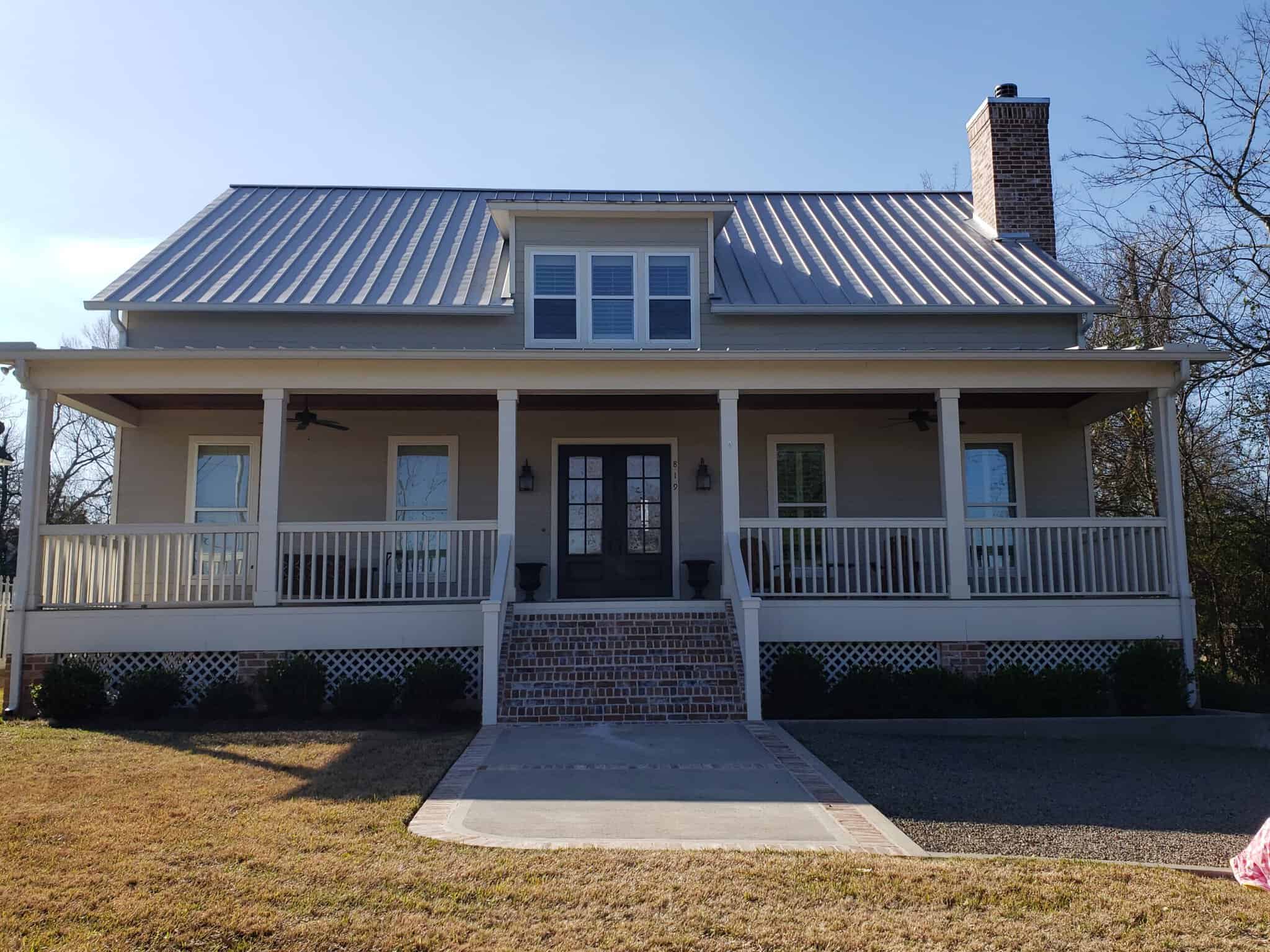 Dreams 2 Reality Custom Homes - Gess Home Front Exterior front exterior view of a pier and beam house with a long front porch with white railing and light red brick staircase