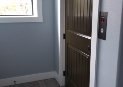 dark brown door with elevator control panel