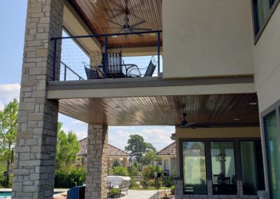 Snyder custom home back exterior two story porch and balcony