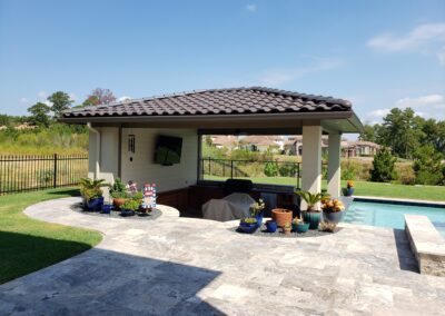 Snyder custom home pool cabana with mounted tv and lounge furniture
