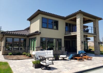 Snyder custom home back of home two story tan and stone stucco
